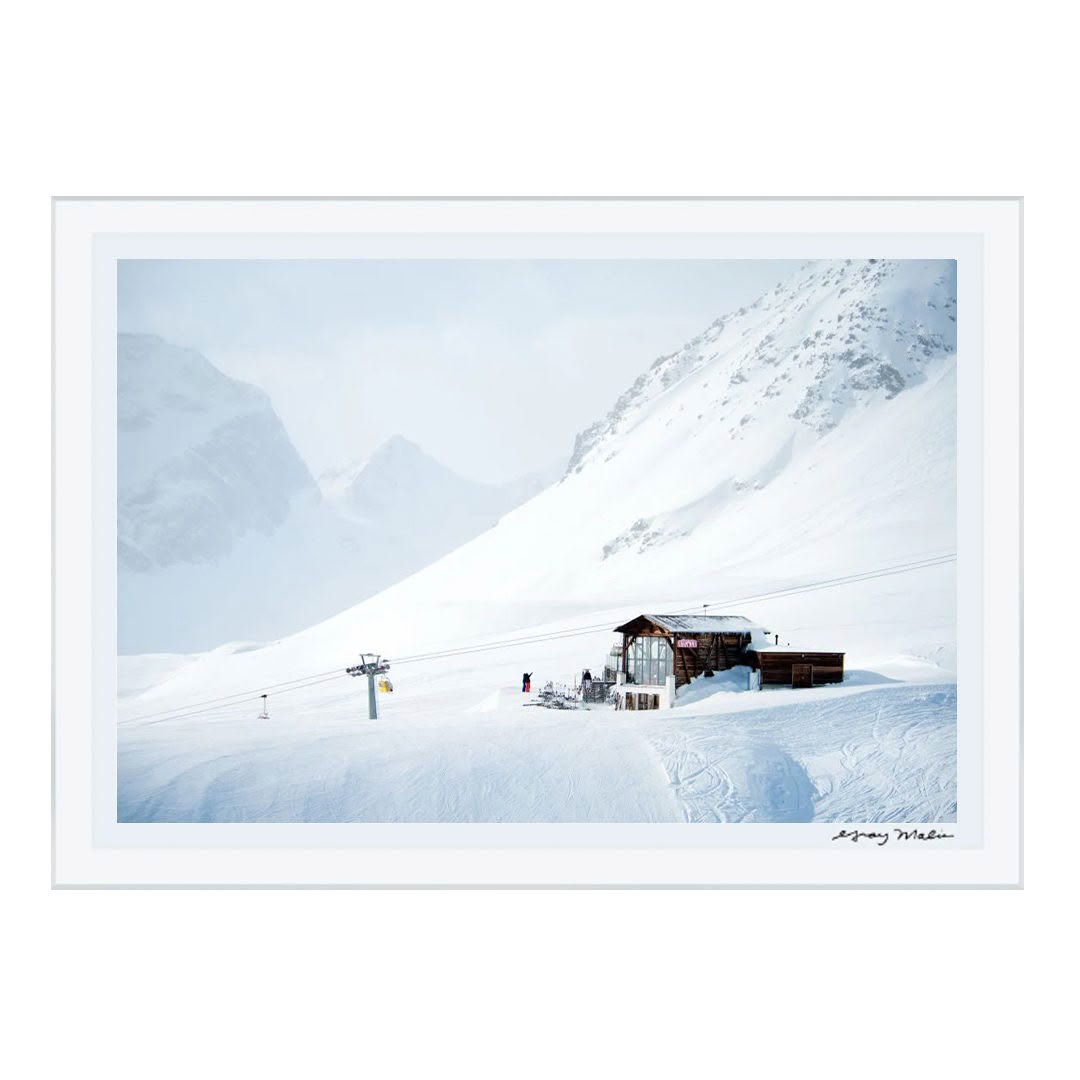 Snow-covered mountain with ski lift and cabin