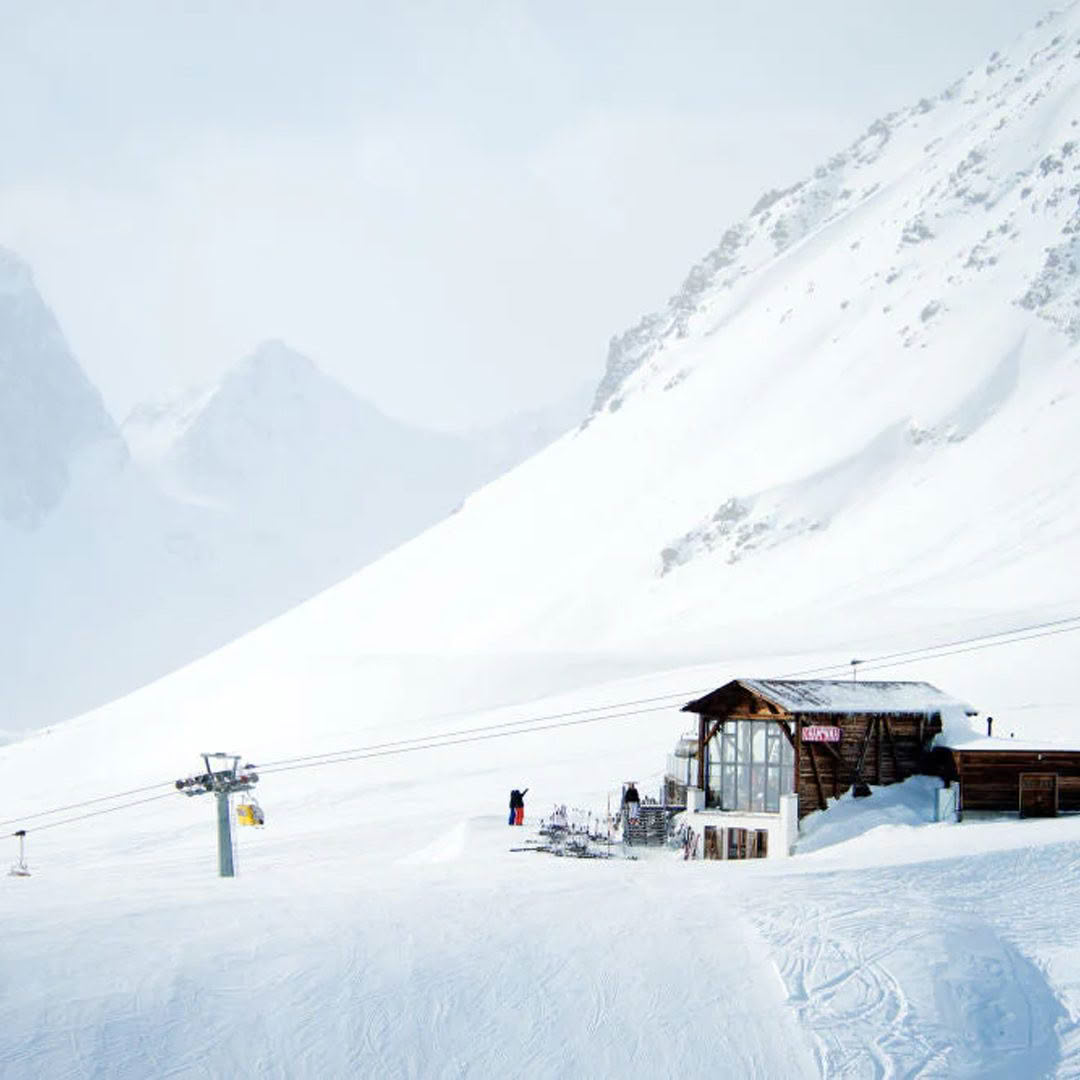 Snow-covered ski resort with chairlift and cabin