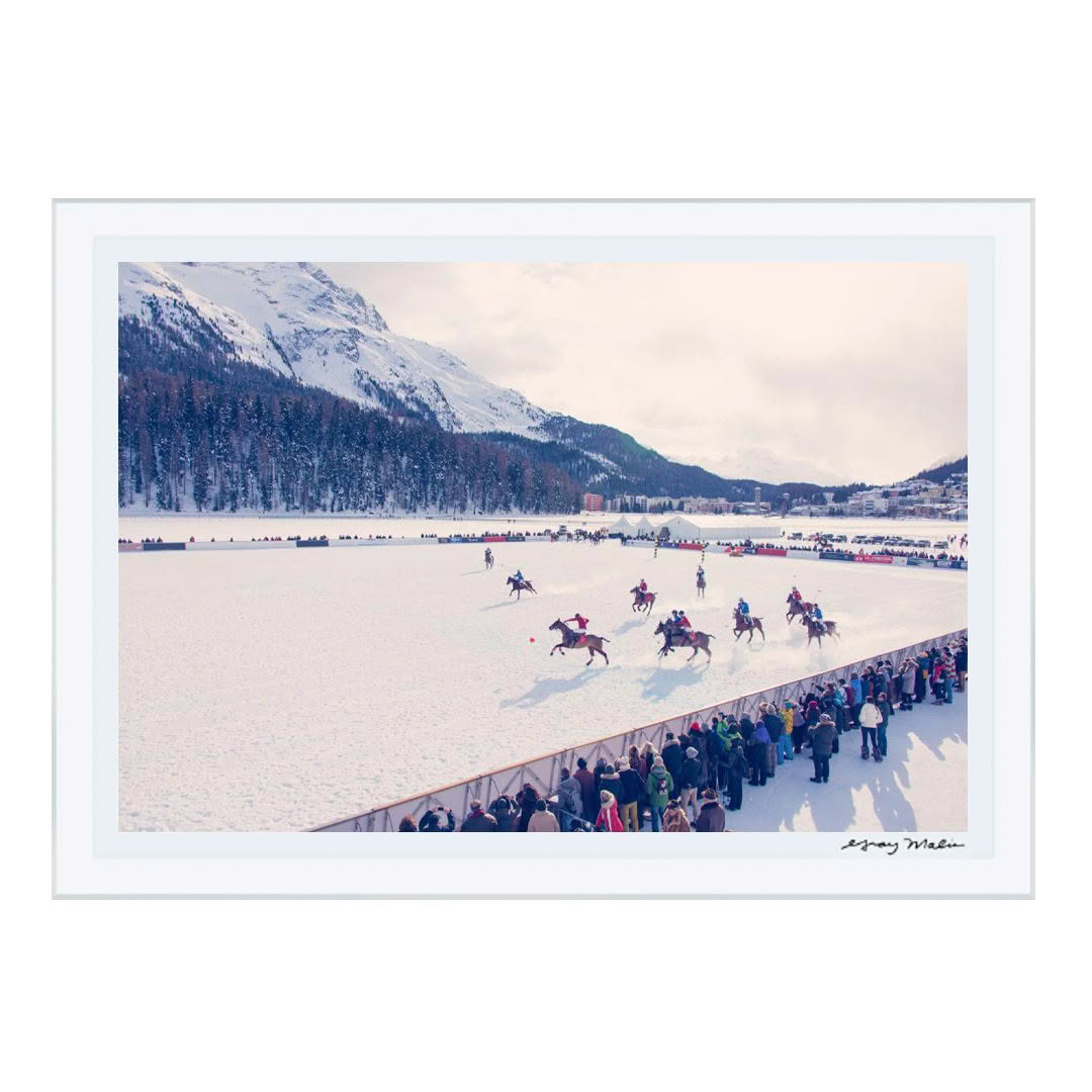 Horse skijoring race on snow with mountain backdrop