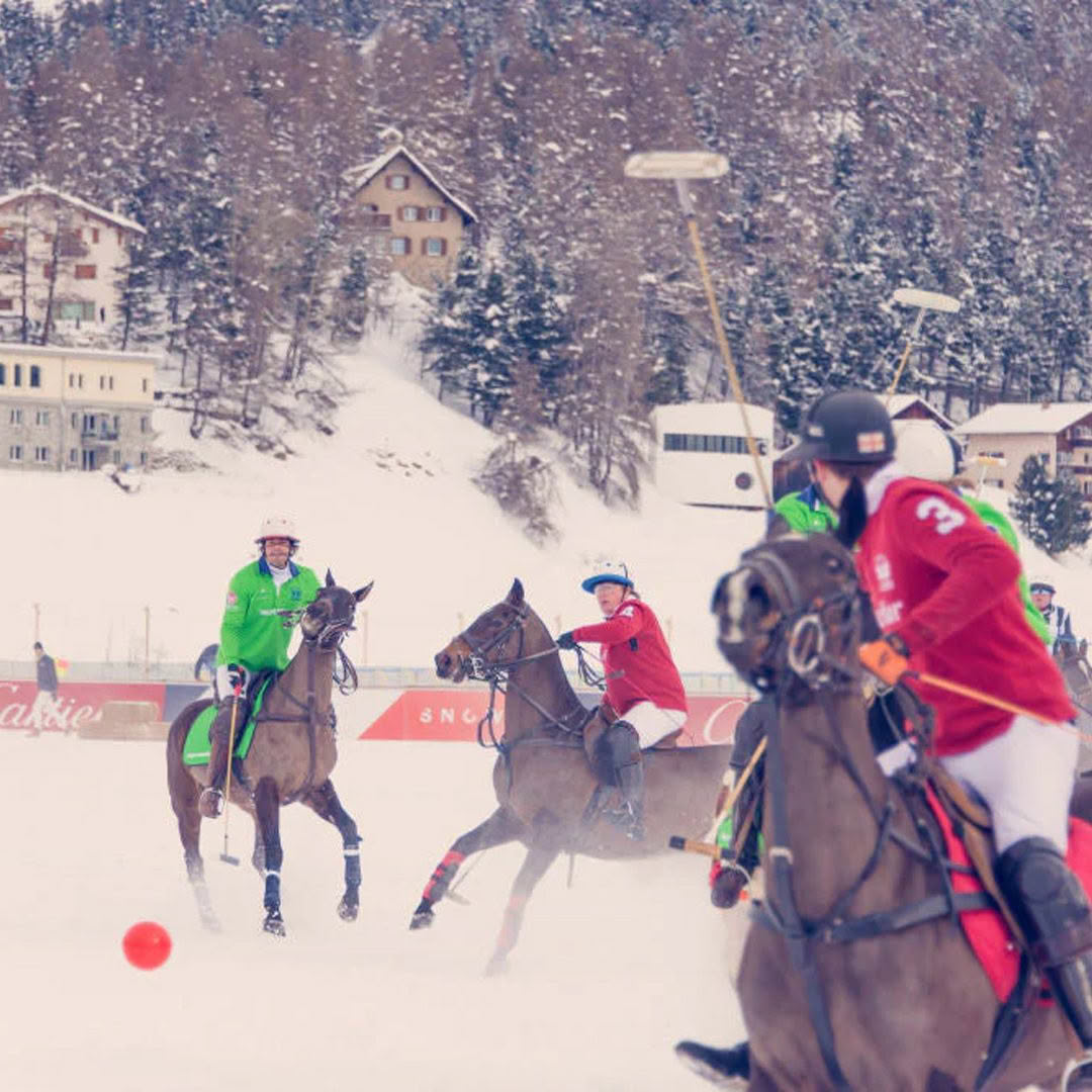 Players competing in snowy outdoor polo match