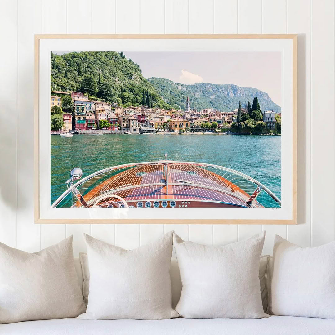 Framed picture of scenic lakeside village and boat