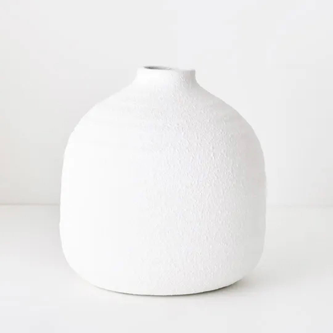 White textured ceramic vase on light background