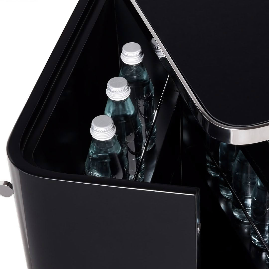 Open black mini fridge storing bottled water