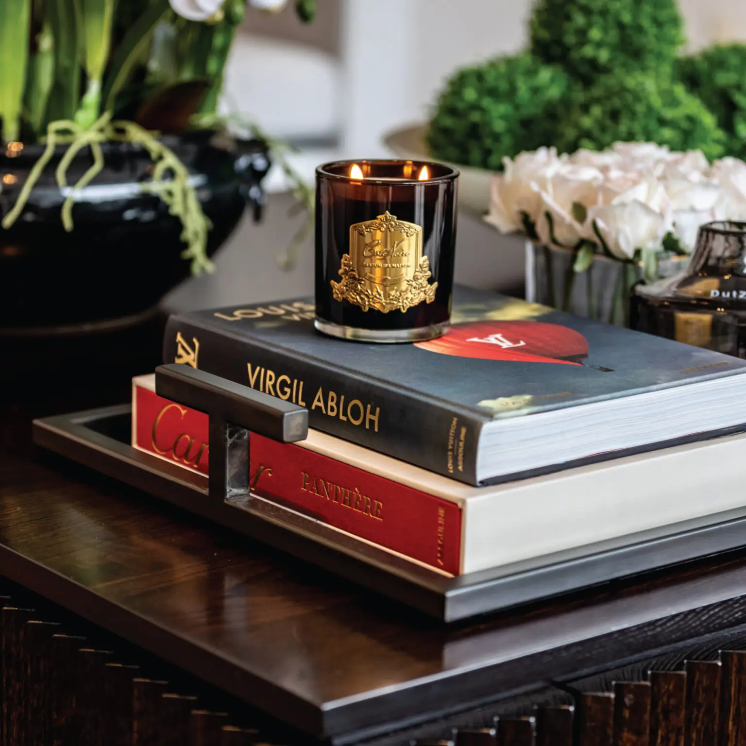 Lit candle on stack of books, elegant home decor