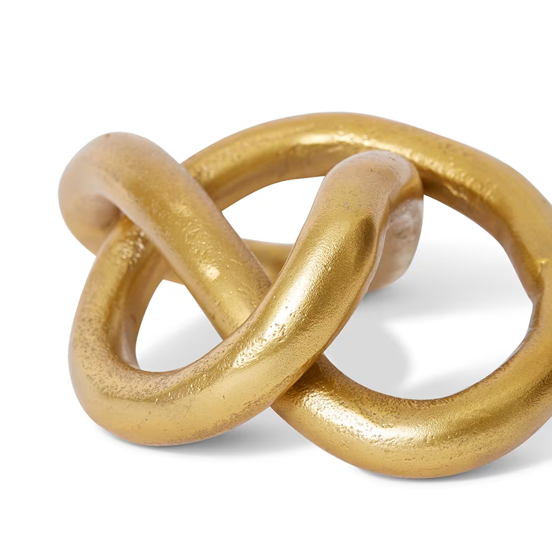 Golden interlocked rings on white background