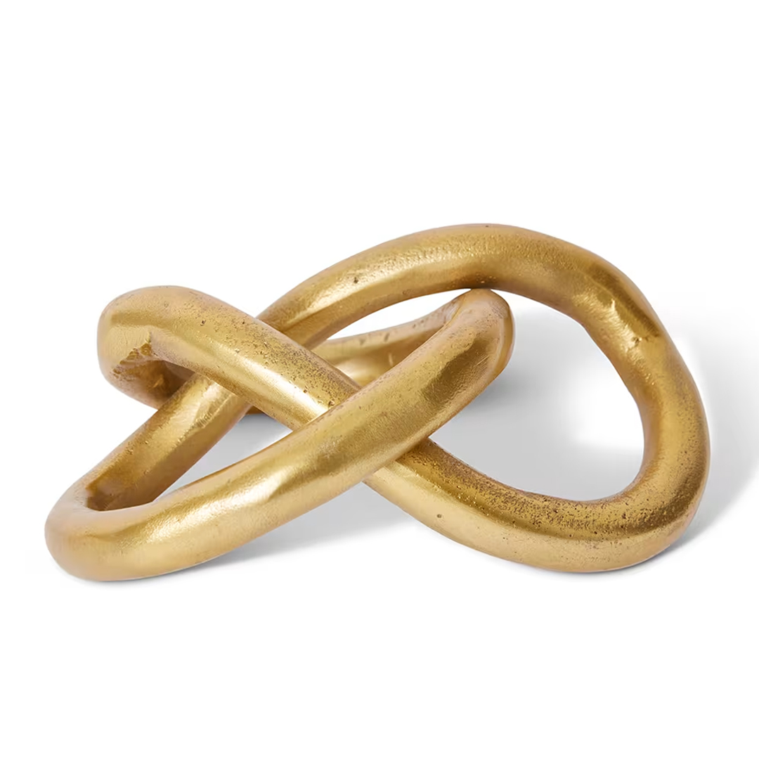 Golden intertwined rings on white background