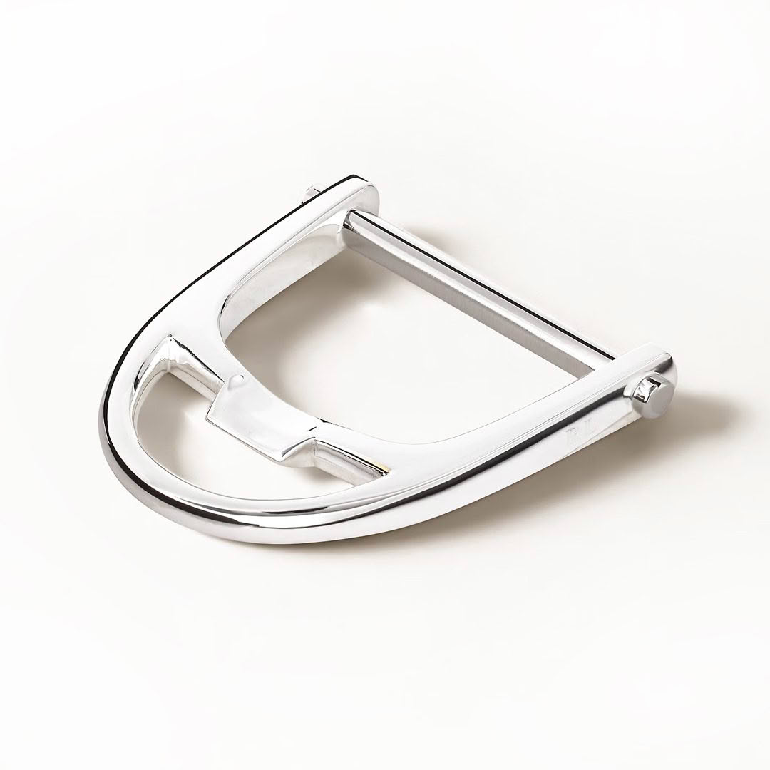Shiny metal horseshoe on white background