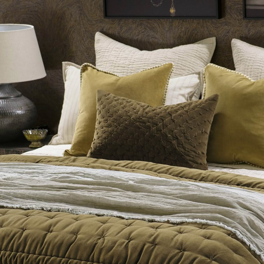 Elegant bedroom with gold and brown decorative pillows