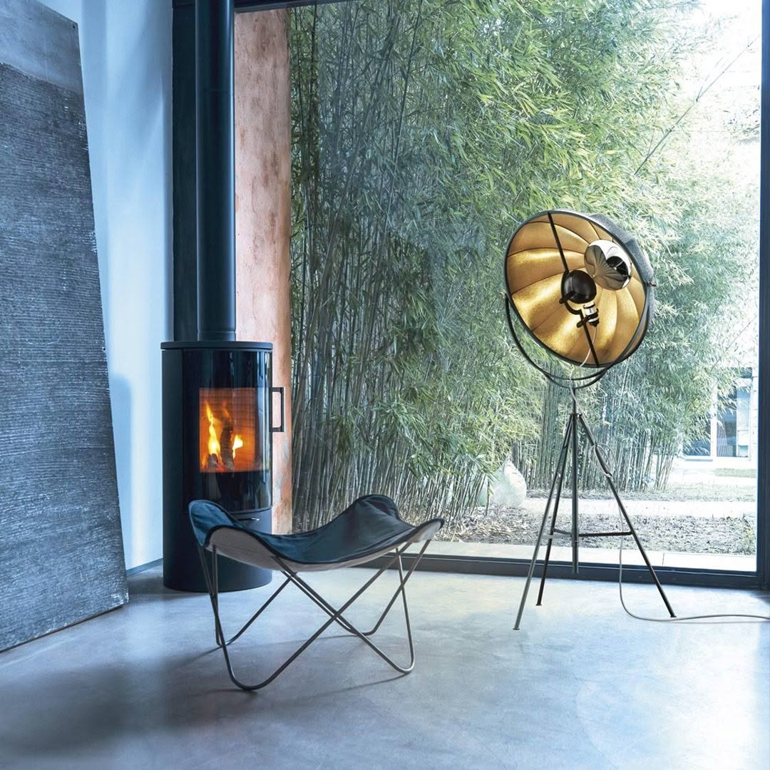 Modern room with fireplace, chair, and unique gold lamp