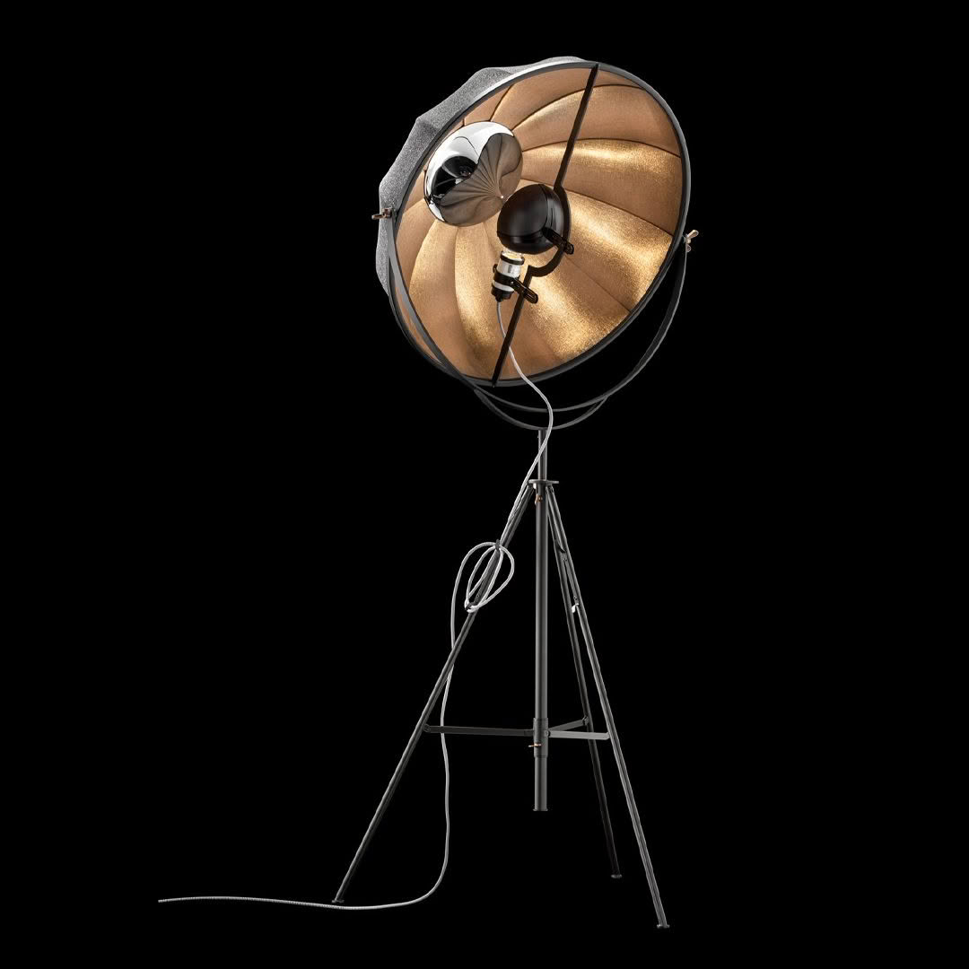 Vintage-style studio light on tripod, black background