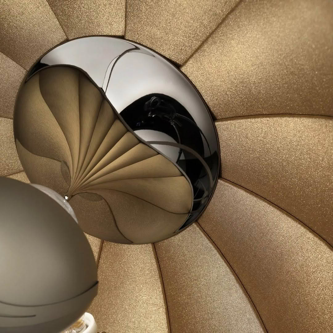 Reflective sphere on golden textured background