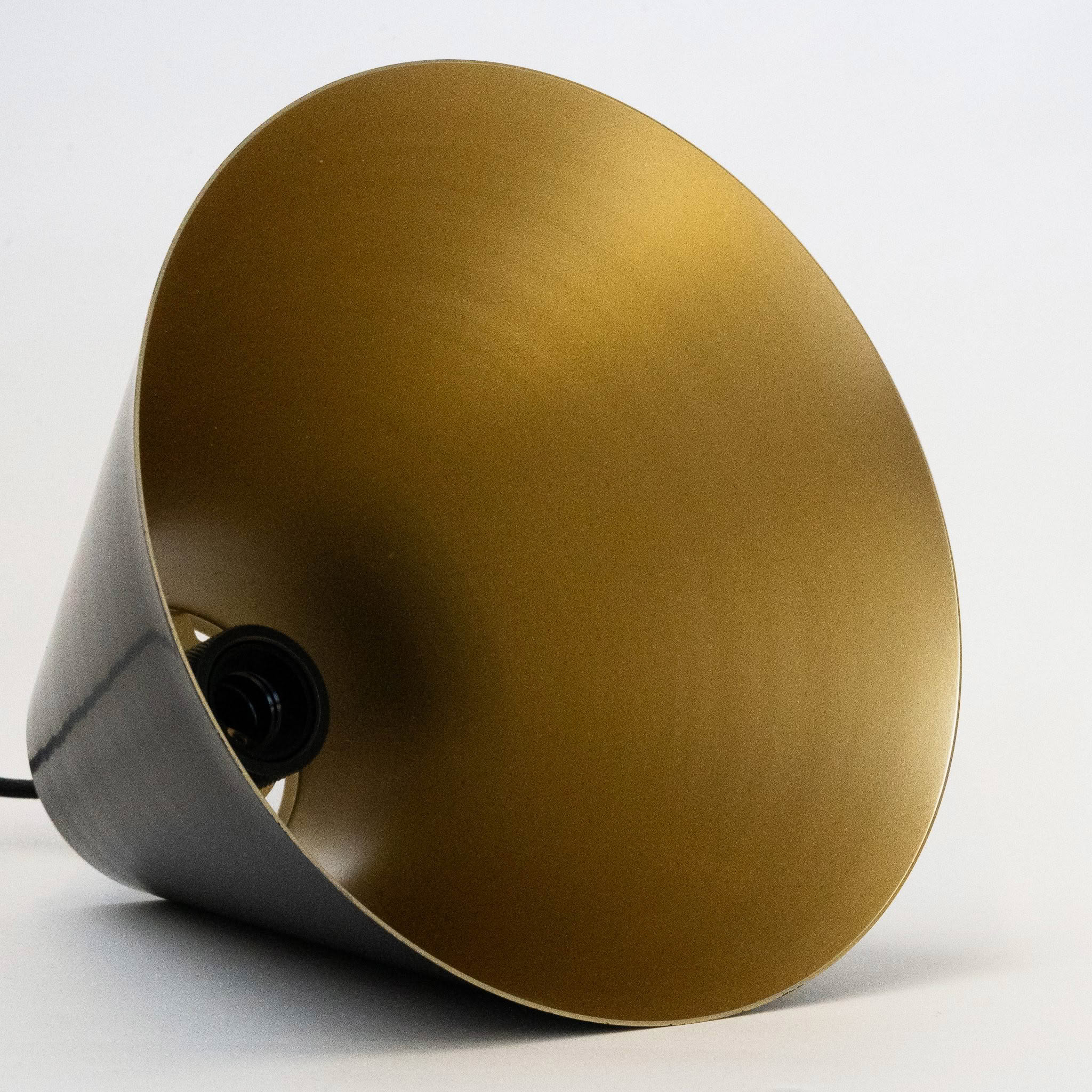 Gold interior of modern lampshade against white background