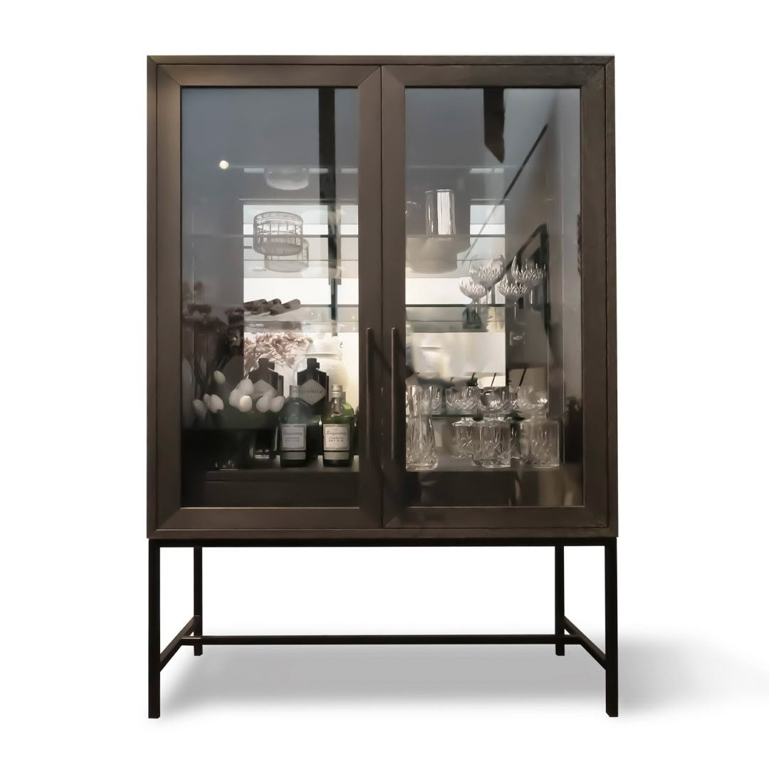 Elegant glass-fronted cabinet filled with glasses and bottles