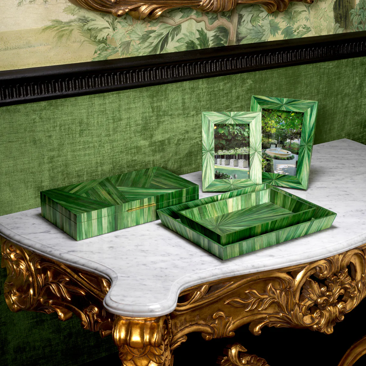Green malachite boxes and frames on marble table