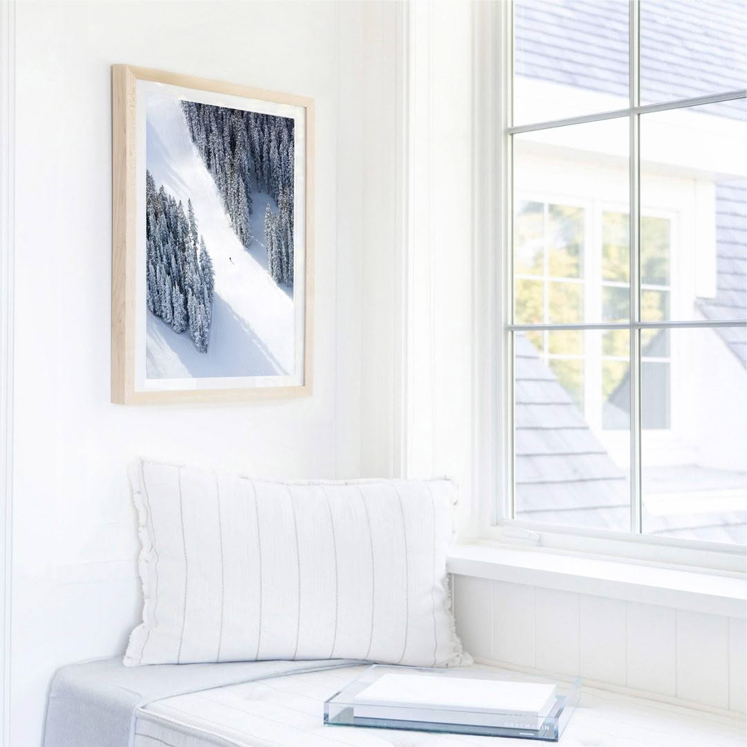 Sunny window nook with snowy landscape painting
