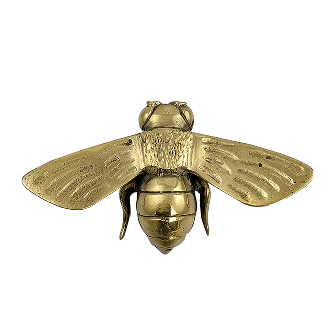 Golden bee sculpture with detailed wings and body