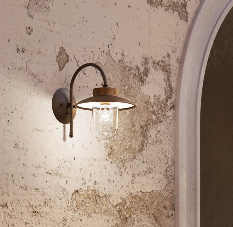Vintage wall sconce on textured concrete wall