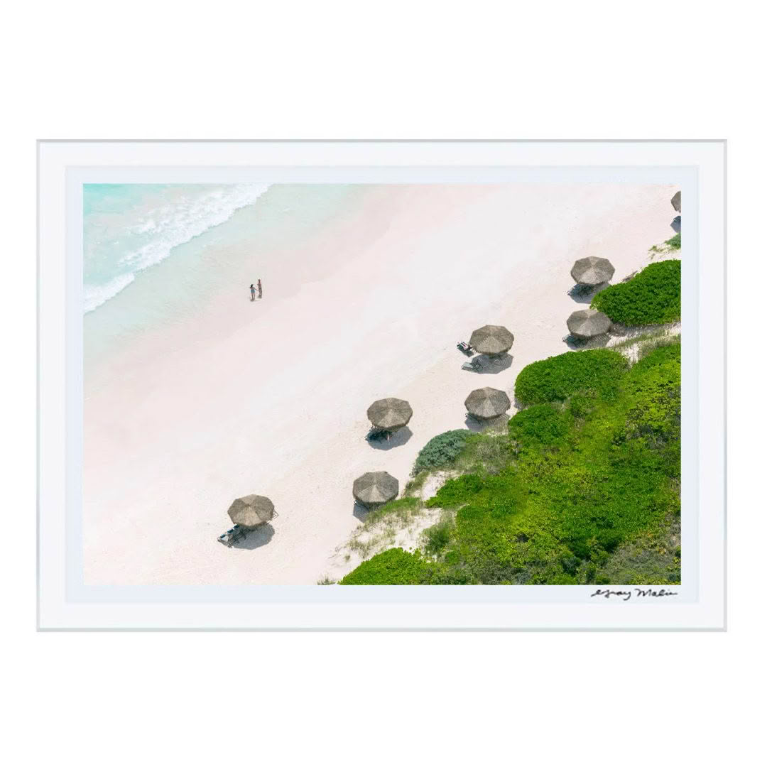 Aerial view of beach with umbrellas and two people