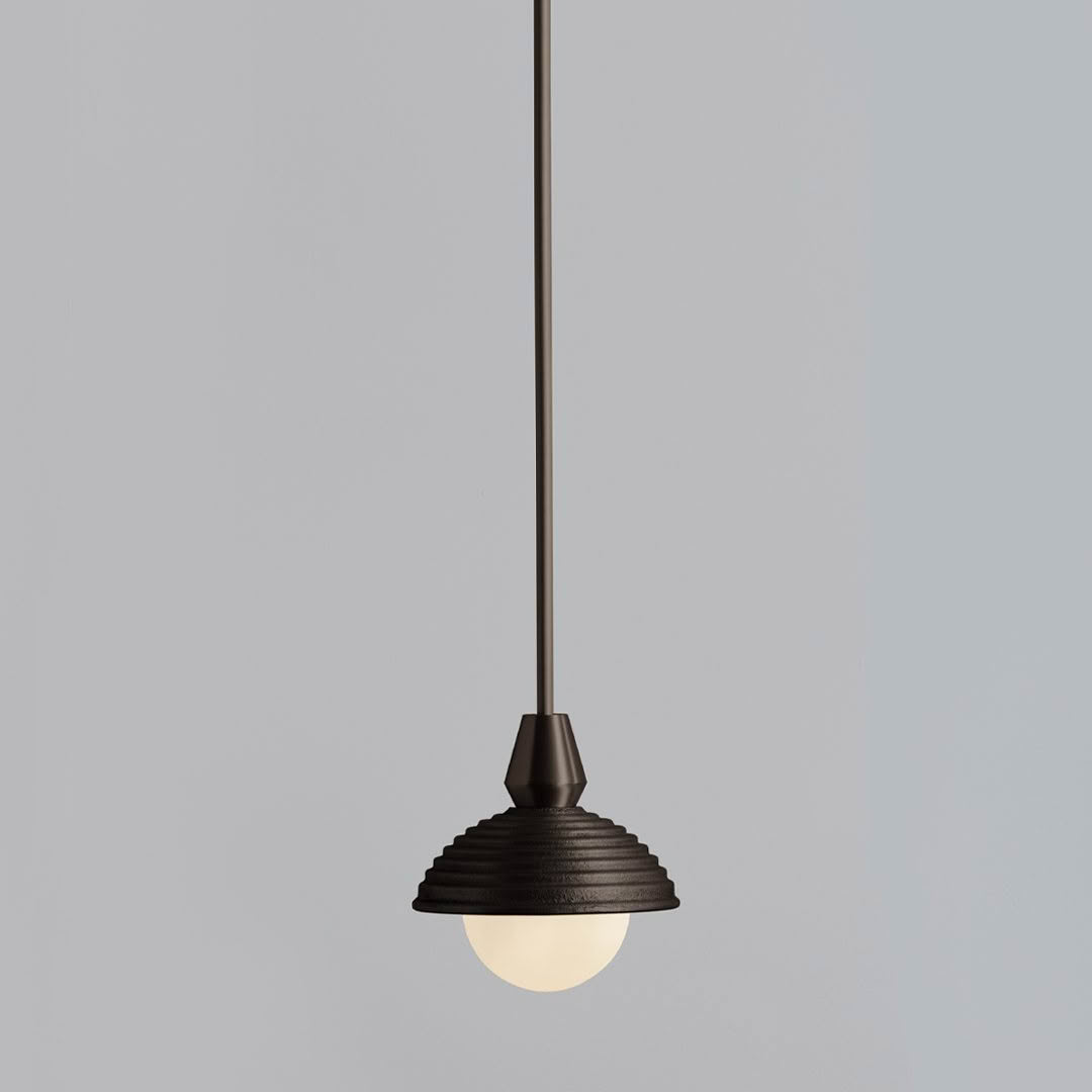 Minimalist black pendant light against gray background