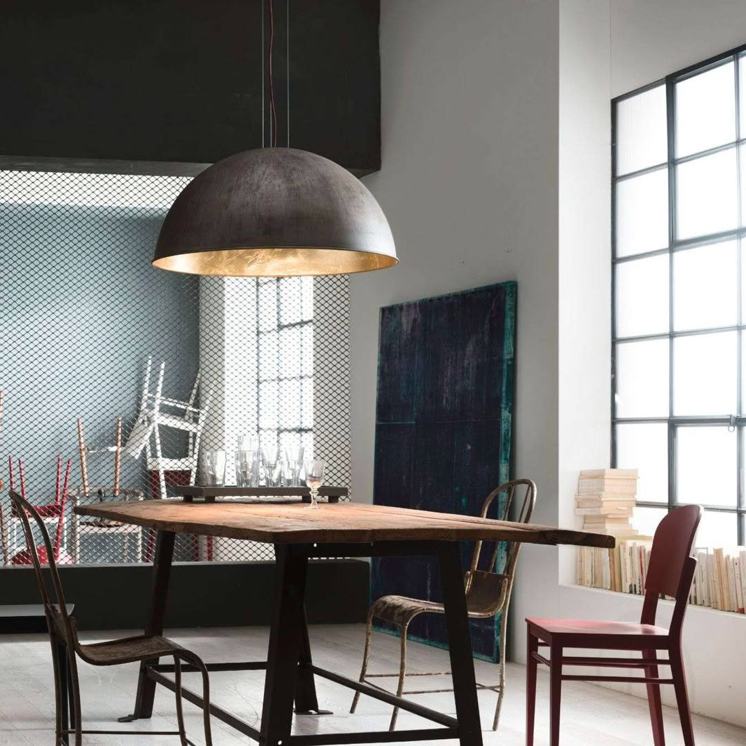 Modern dining room with large pendant light and rustic table