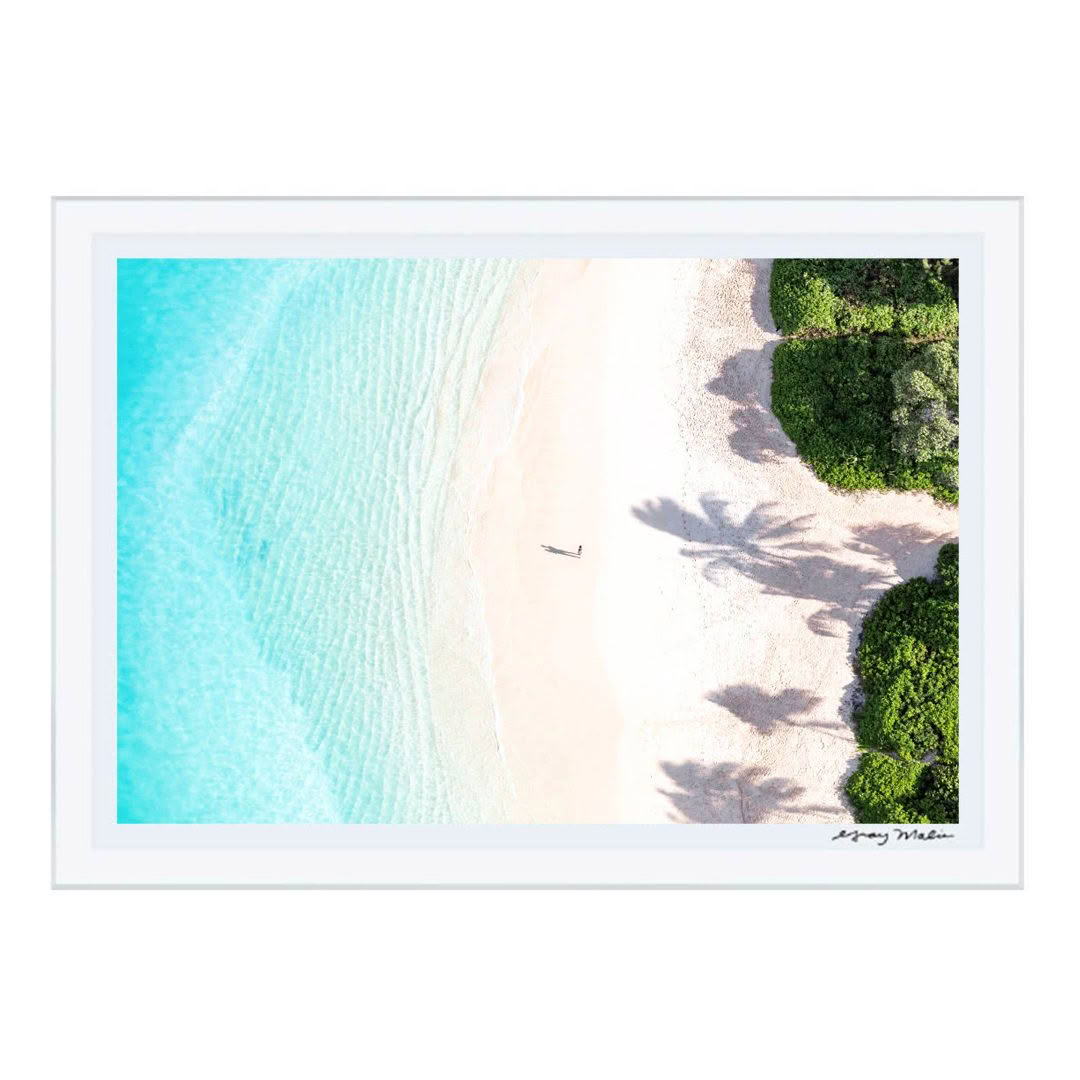 Aerial view of person on bright beach with shadows