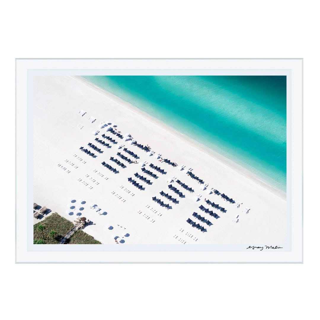 Aerial view of sandy beach with organized umbrellas