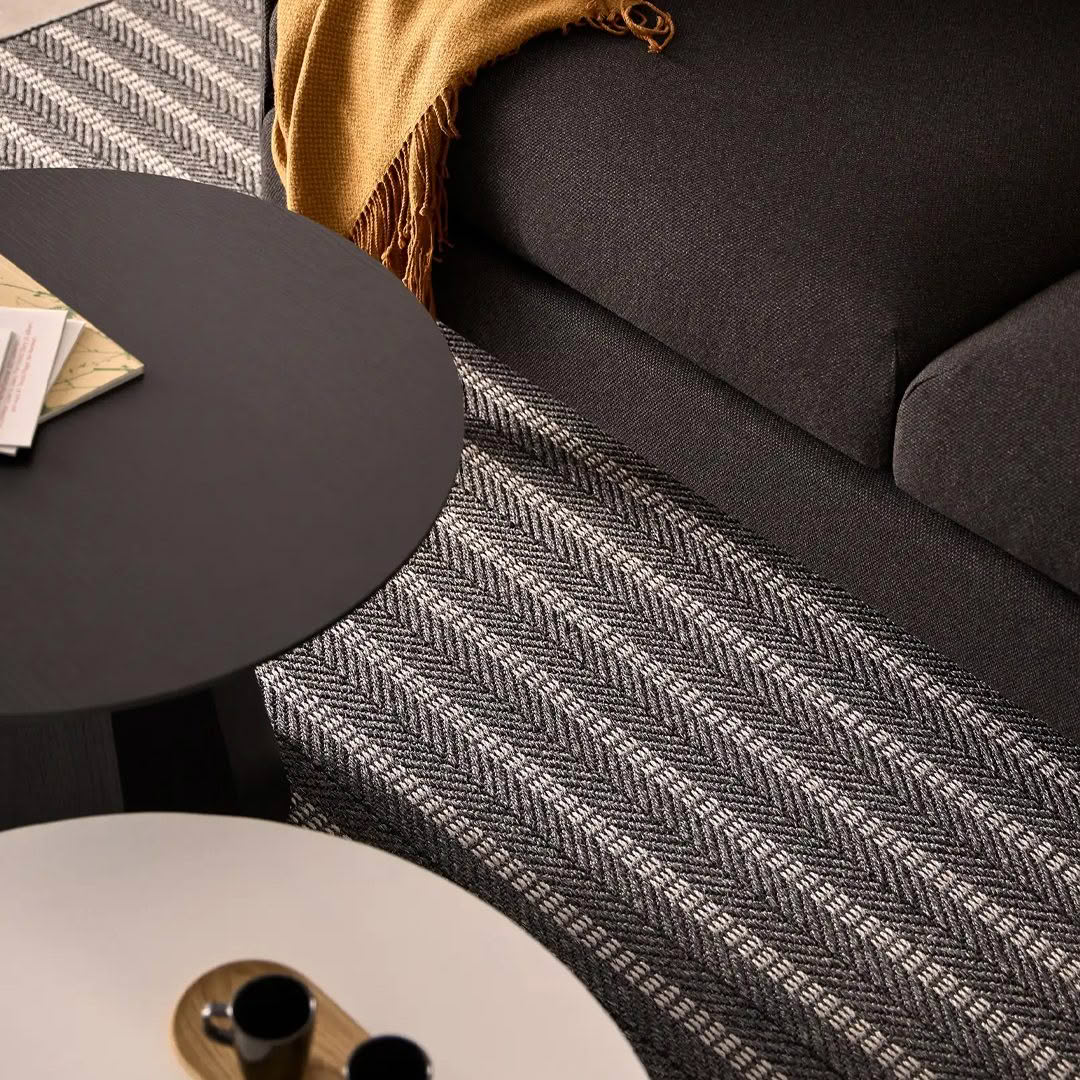 Cozy living room corner with sofa and patterned rug