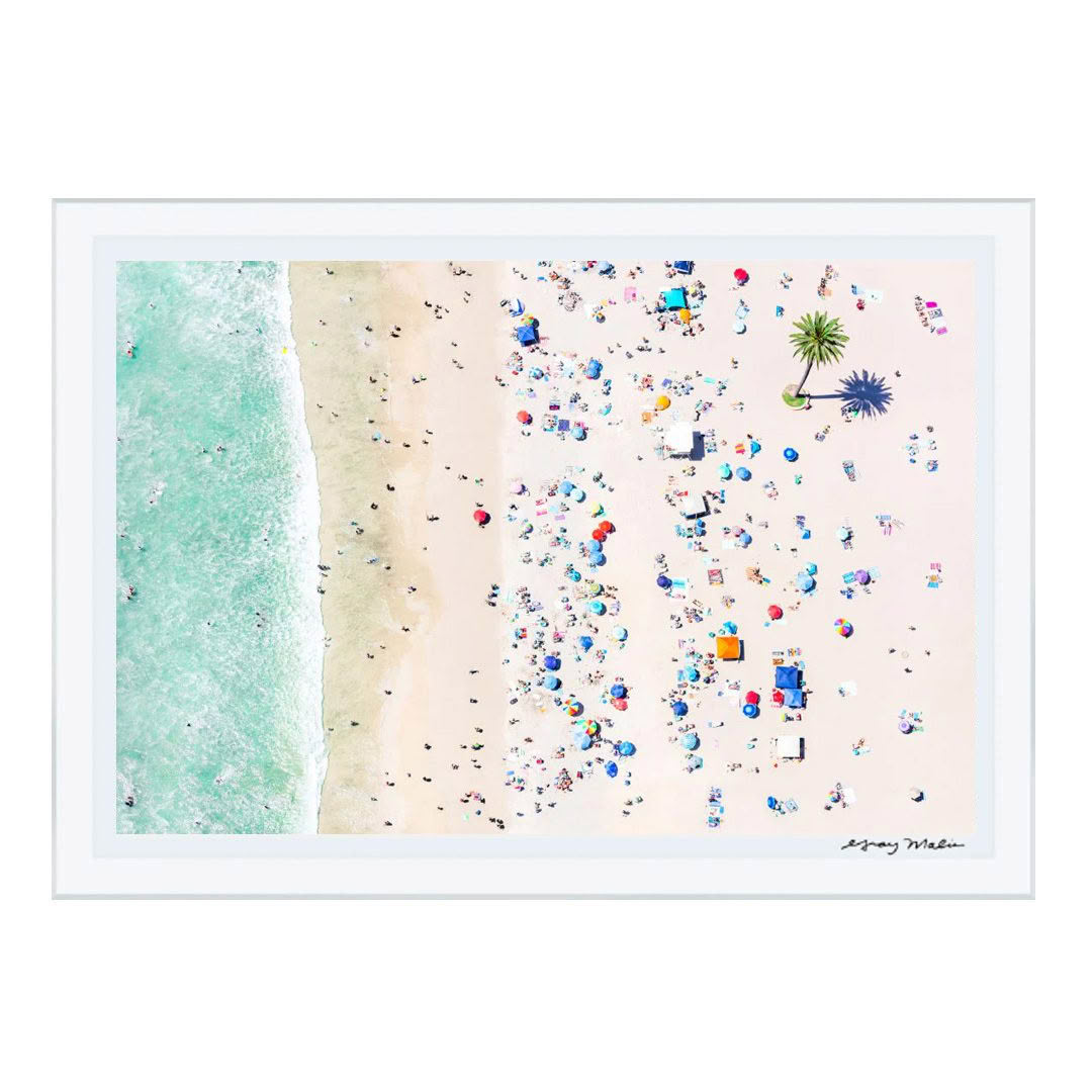 Aerial beach view with people, umbrellas, and turquoise water