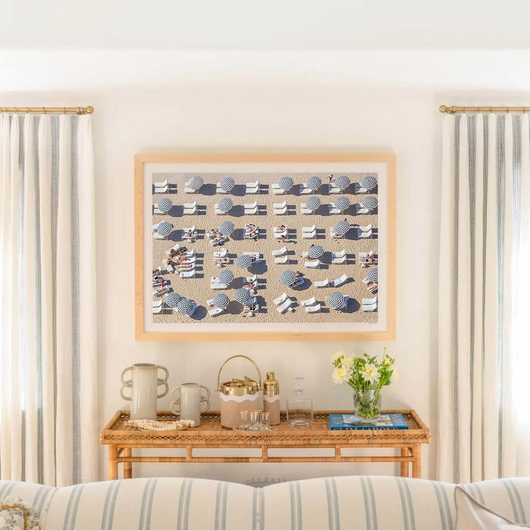 Cozy interior with beach-themed wall art and striped curtains