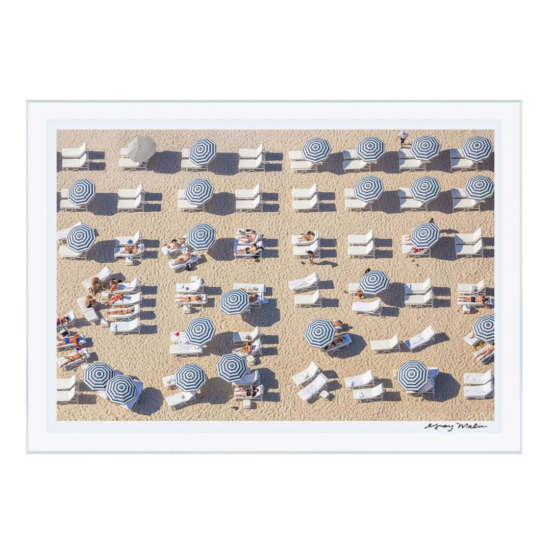 Aerial view of beach with people and striped umbrellas
