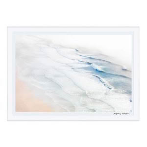 Aerial view of gentle waves on a sandy beach