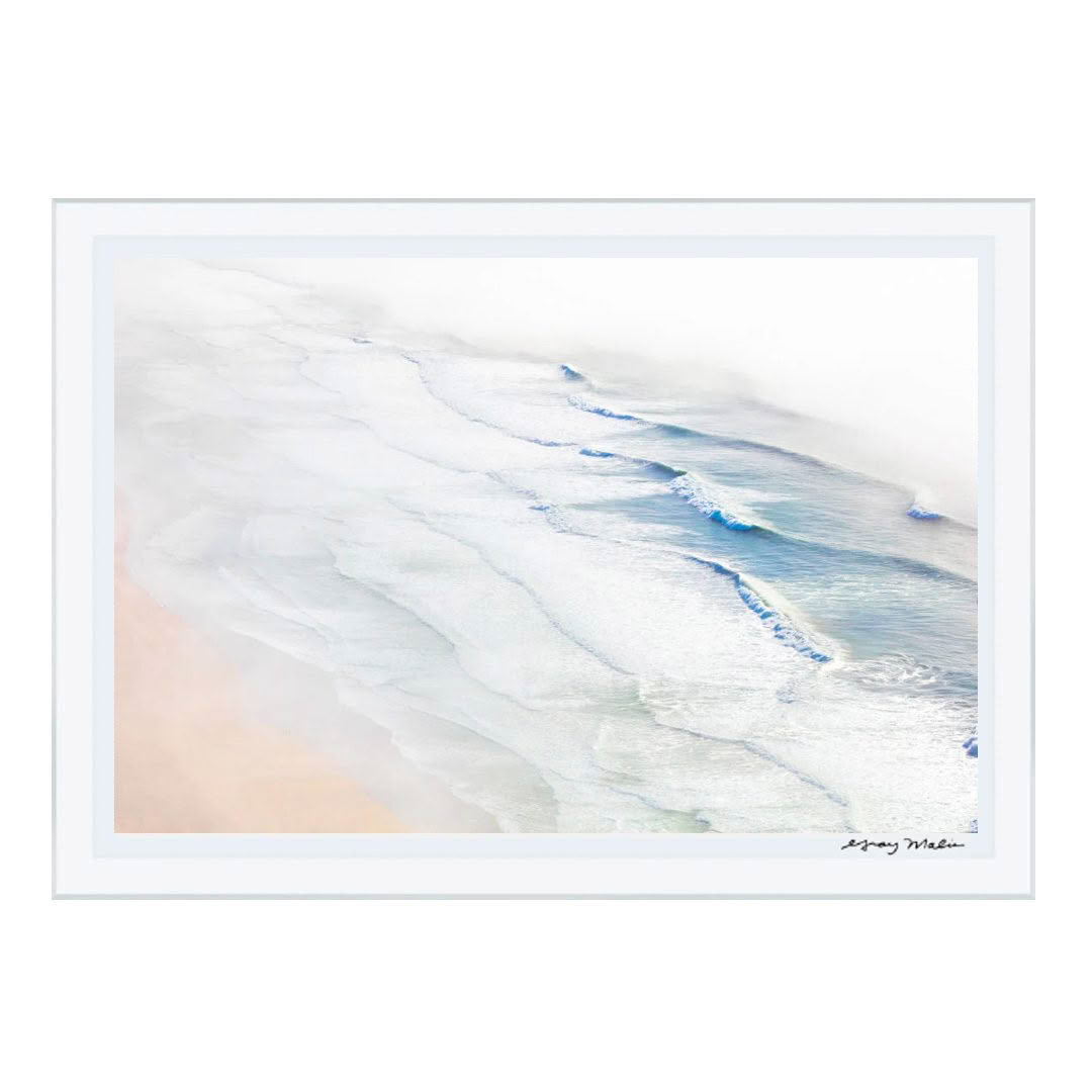 Aerial view of gentle waves on a sandy beach