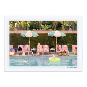Dogs relaxing by pool with umbrellas and lounge chairs