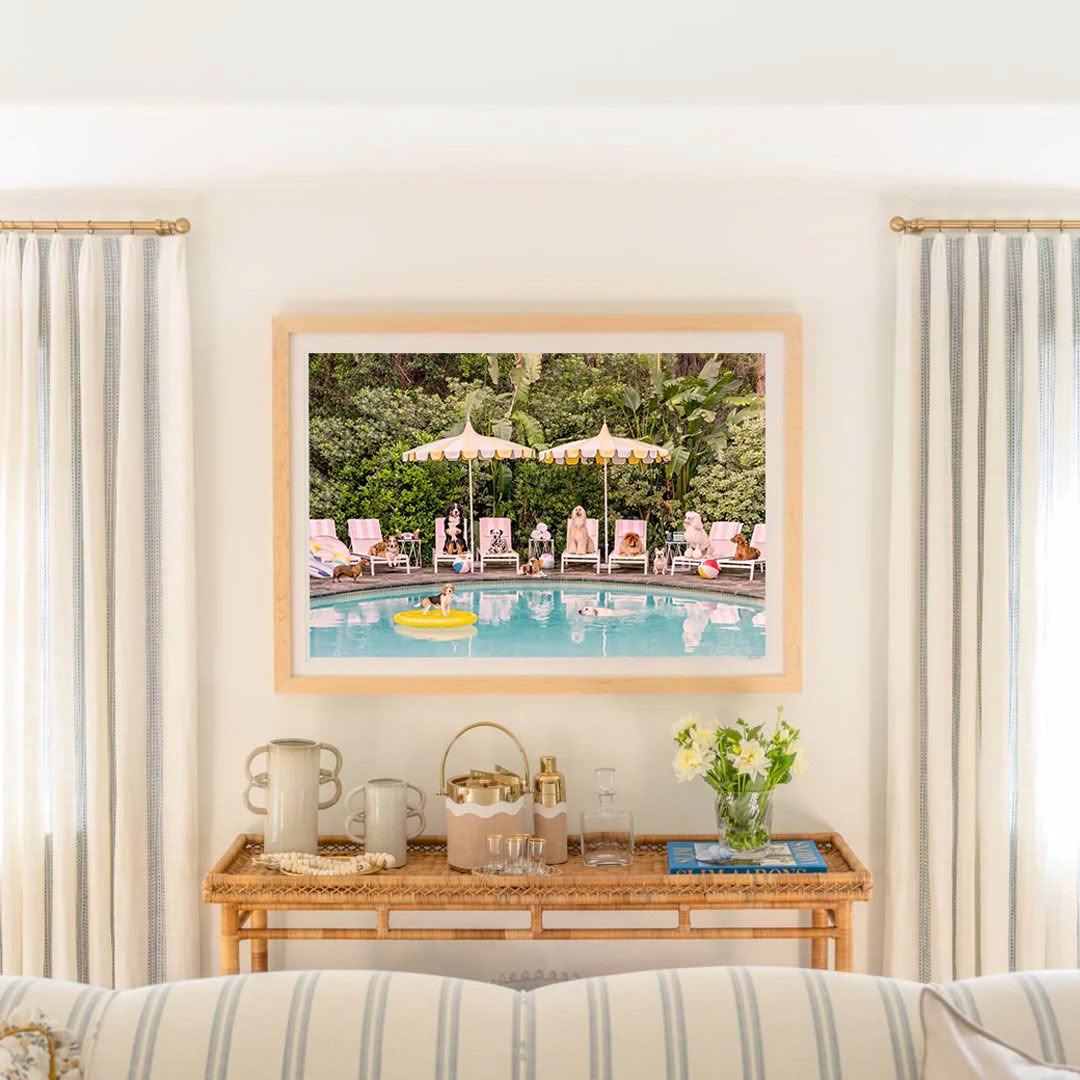 Framed painting of people relaxing by pool in room