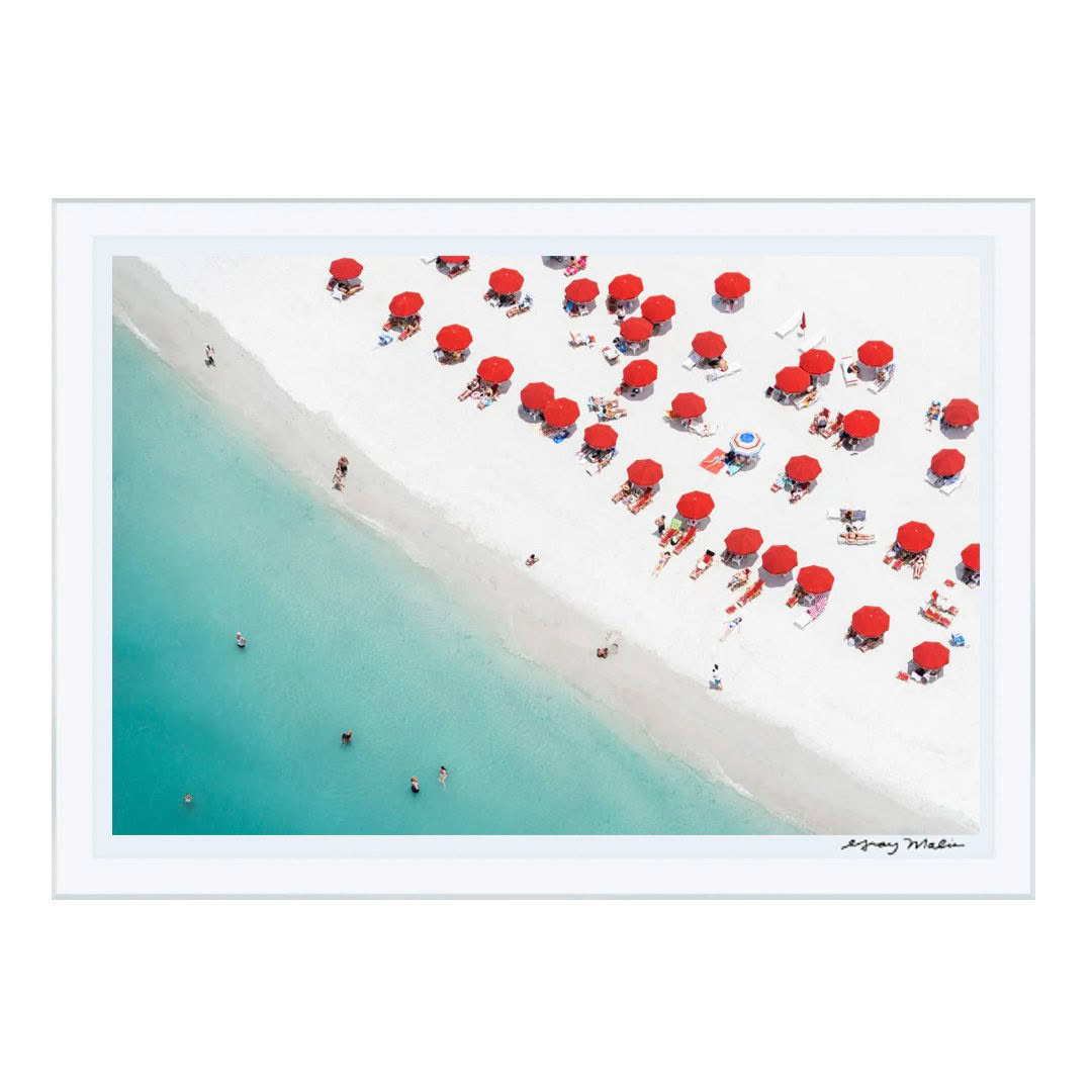 Aerial view of beach with red umbrellas and swimmers