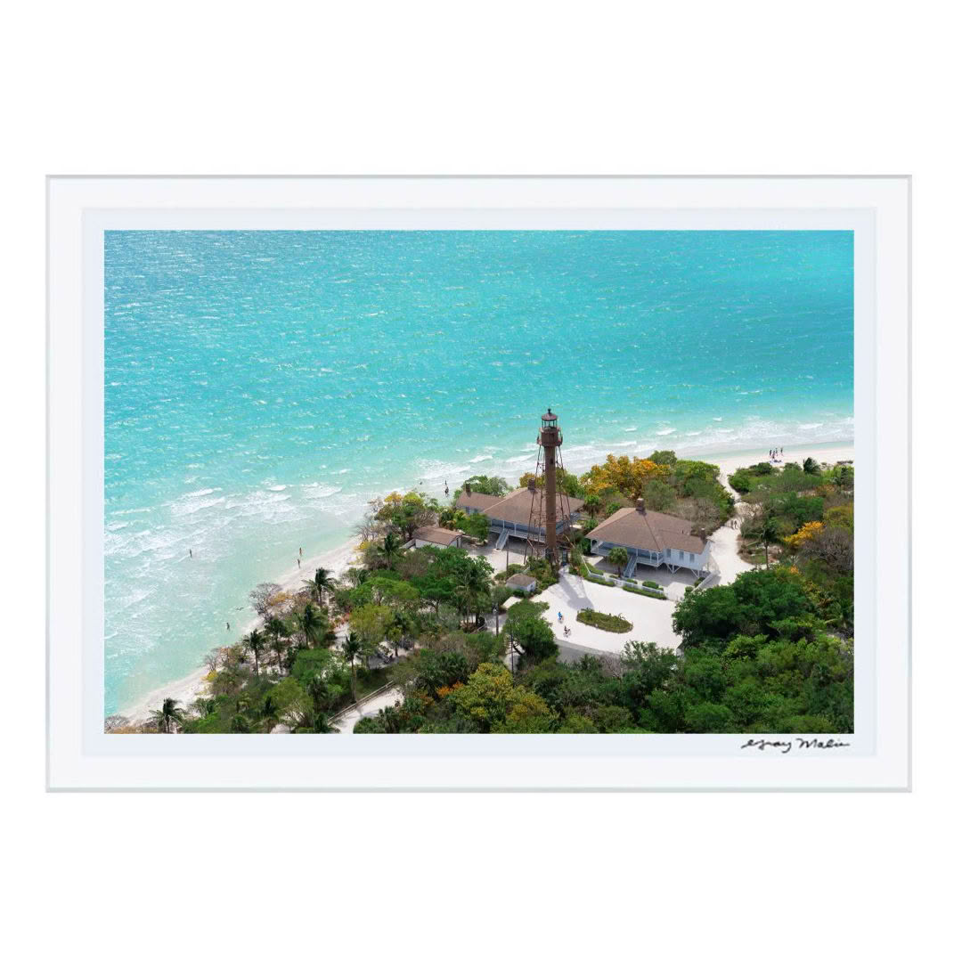 Aerial view of a coastal lighthouse with turquoise sea