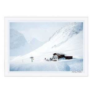 Snowy mountain ski resort with chairlift and cabin