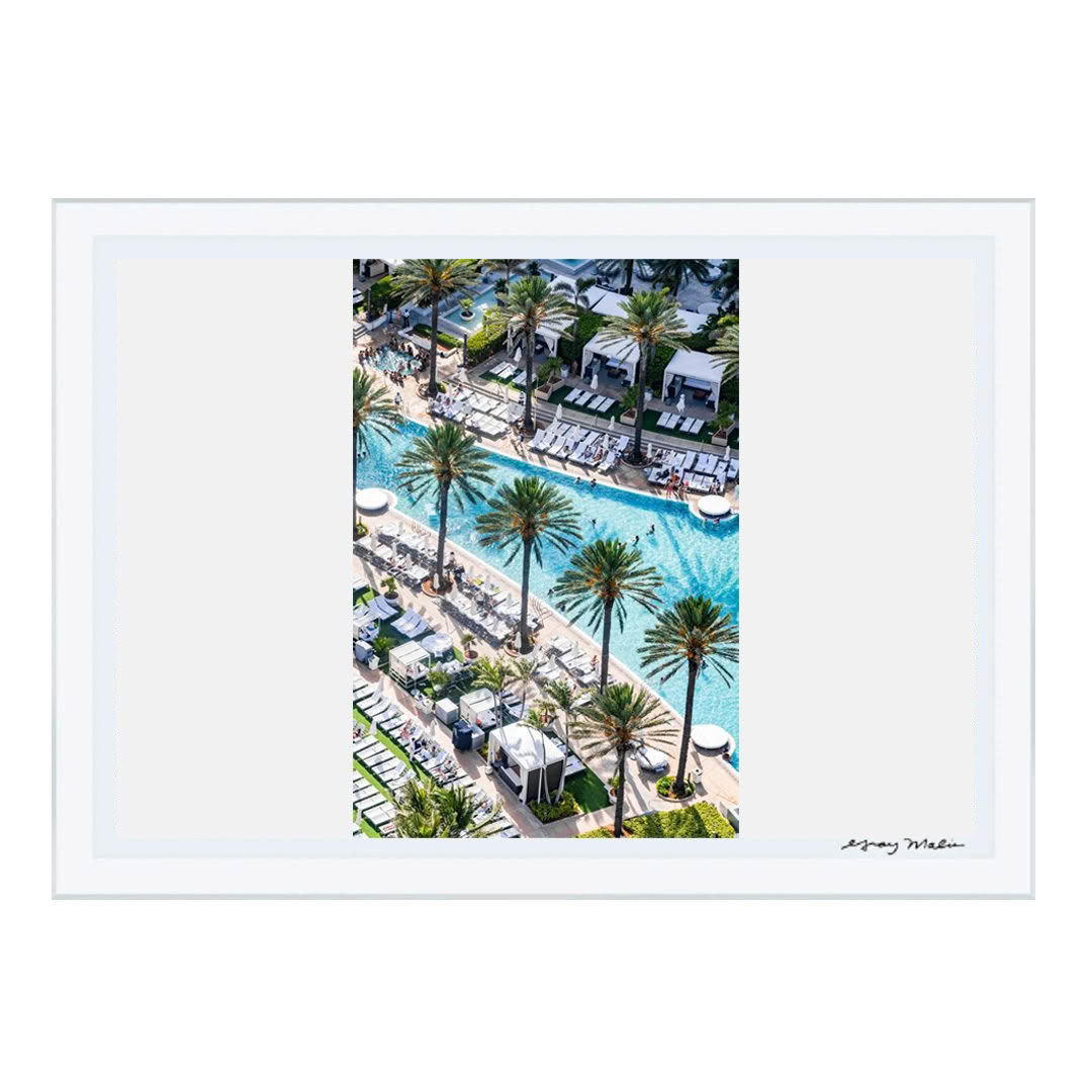 Aerial view of busy resort pool with palm trees