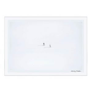 Minimalist snowy landscape with two distant skiers