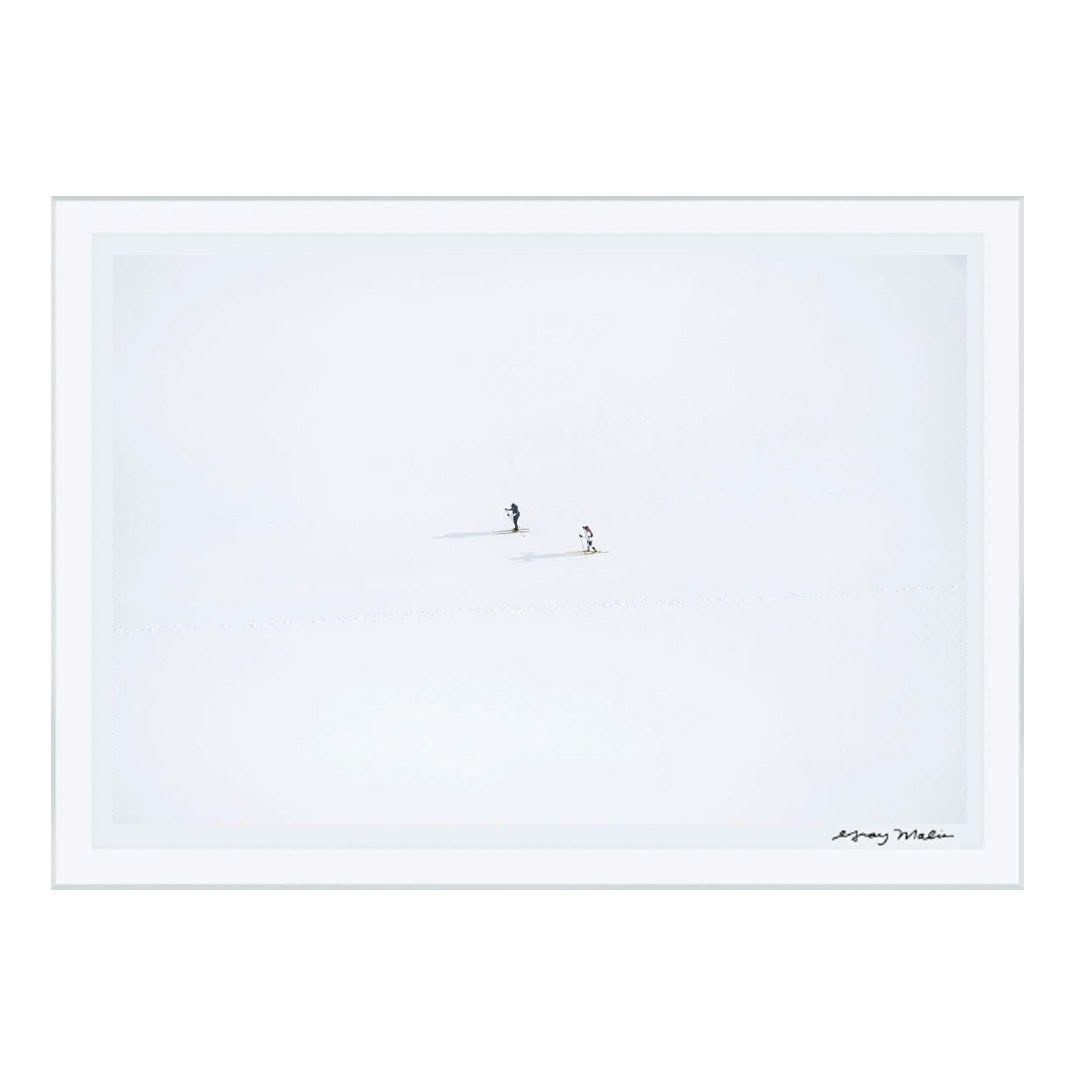 Minimalist snowy landscape with two distant skiers