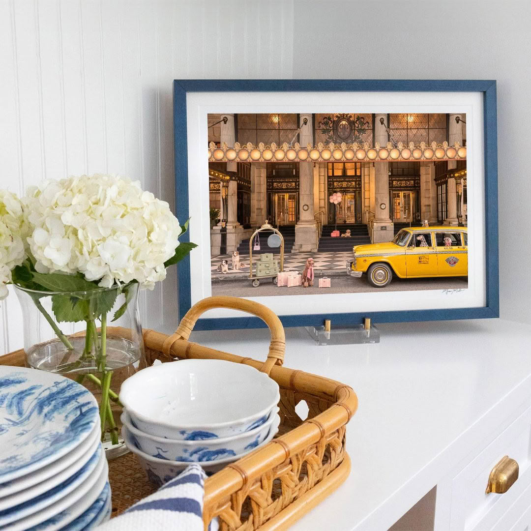 Framed artwork of ornate lobby and yellow taxi