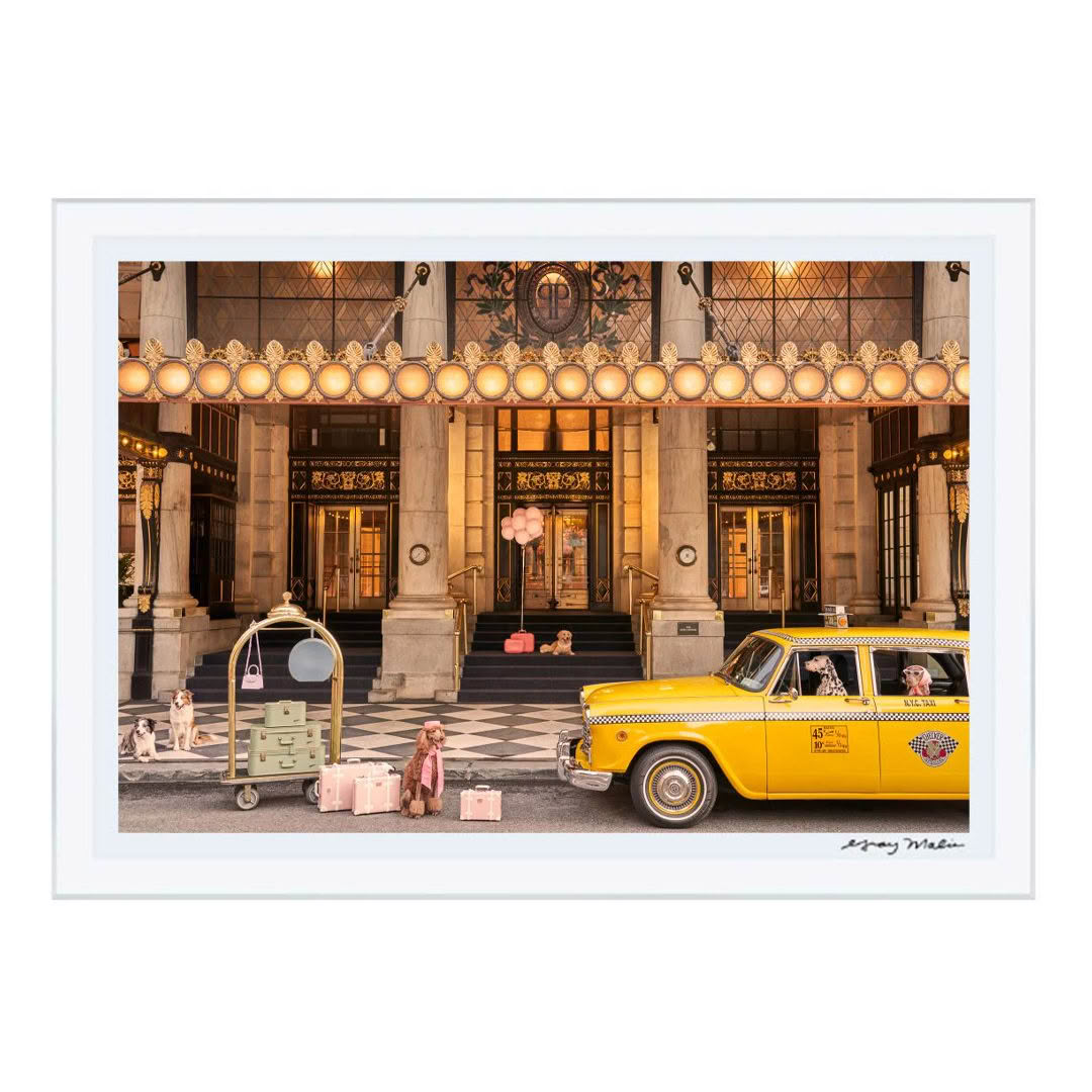 Vintage yellow taxi outside ornate hotel entrance
