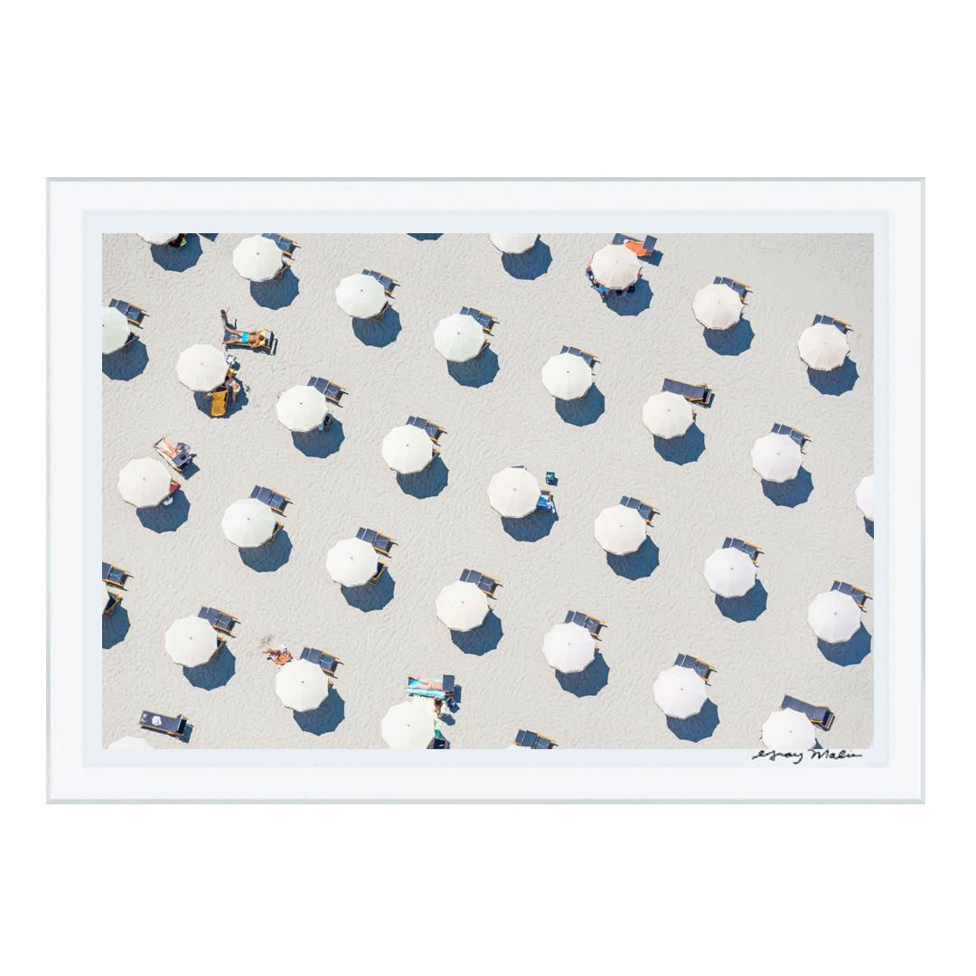 Aerial view of beach umbrellas and sunbathers on sand