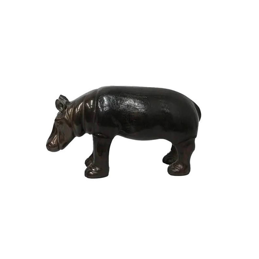 Black ceramic hippopotamus figurine on white background