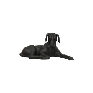 Black sculpted dog lying down isolated on white