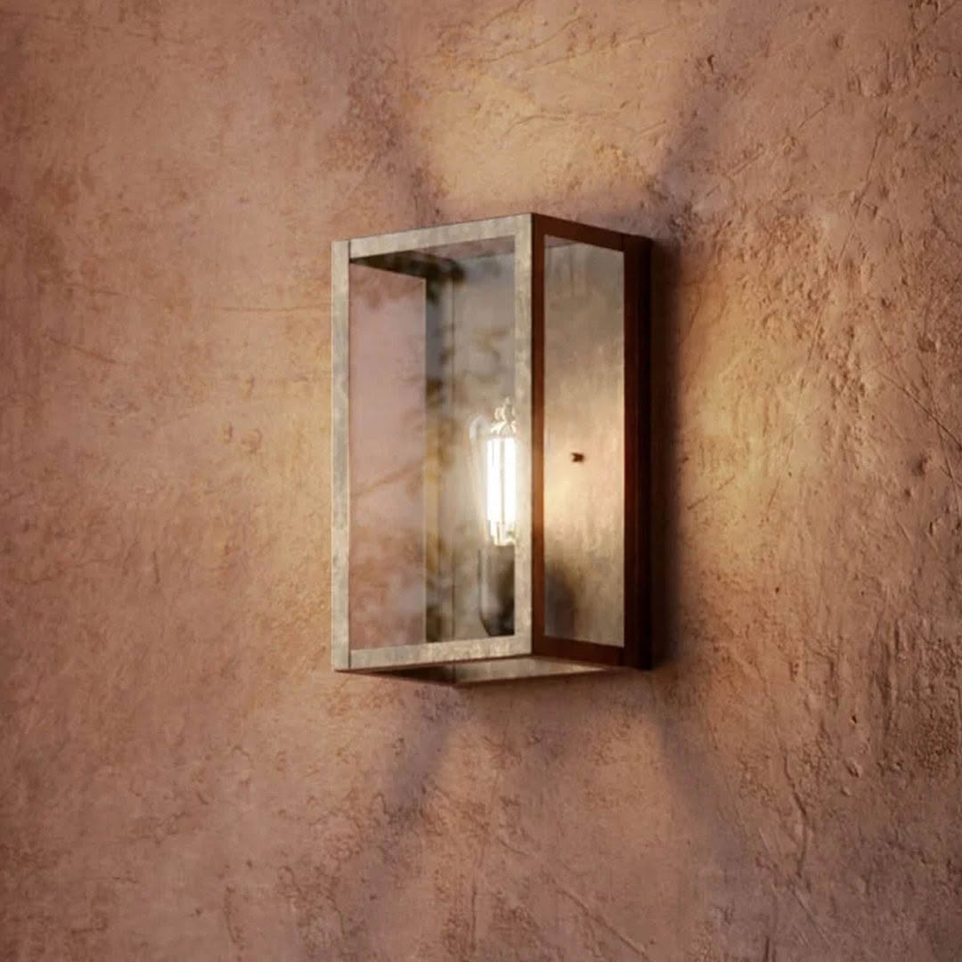 Wall-mounted candle lantern on textured beige wall