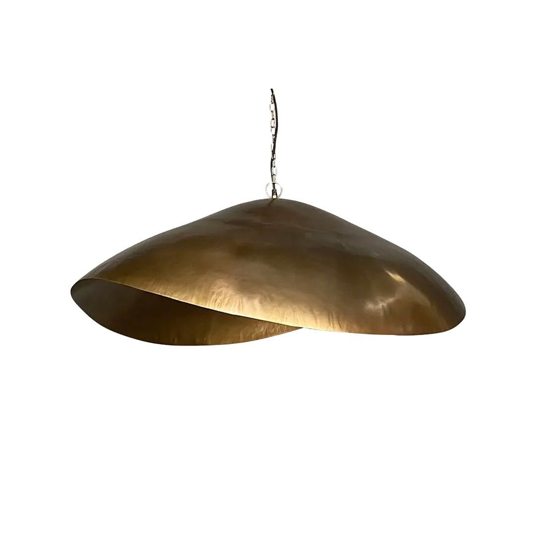 Large brass pendant light hanging on white background