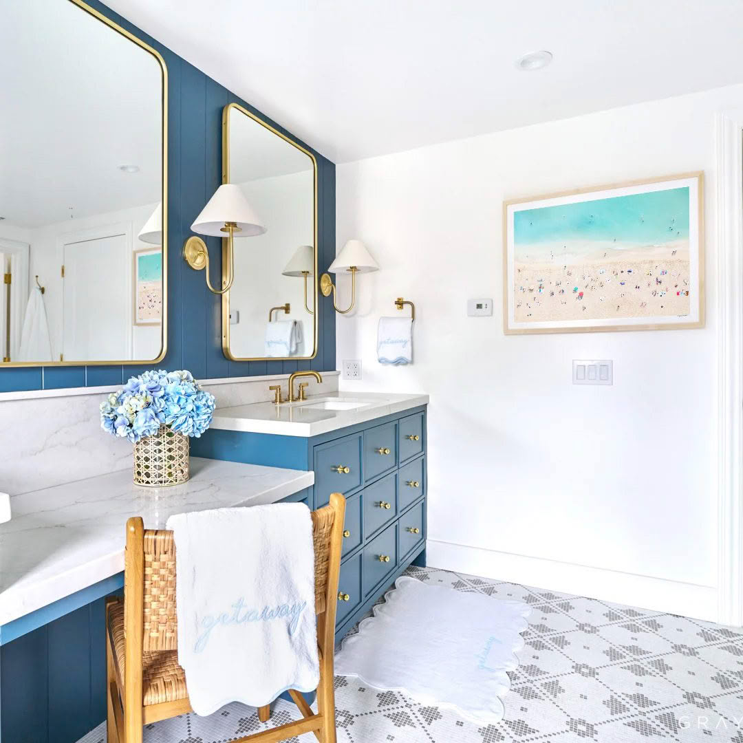 Elegant bathroom with blue vanity and gold accents