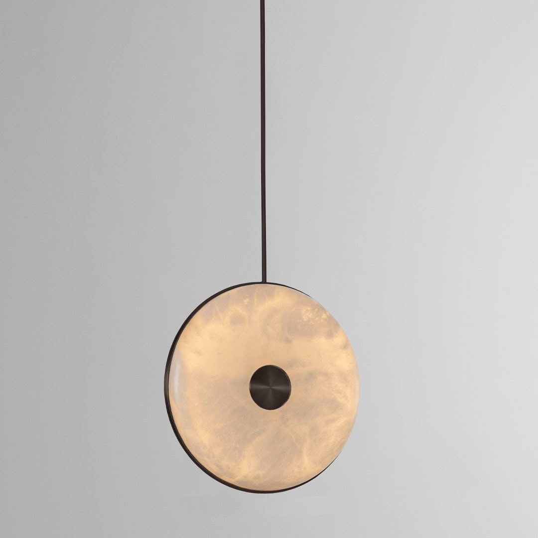 Minimalist circular pendant light on gray background