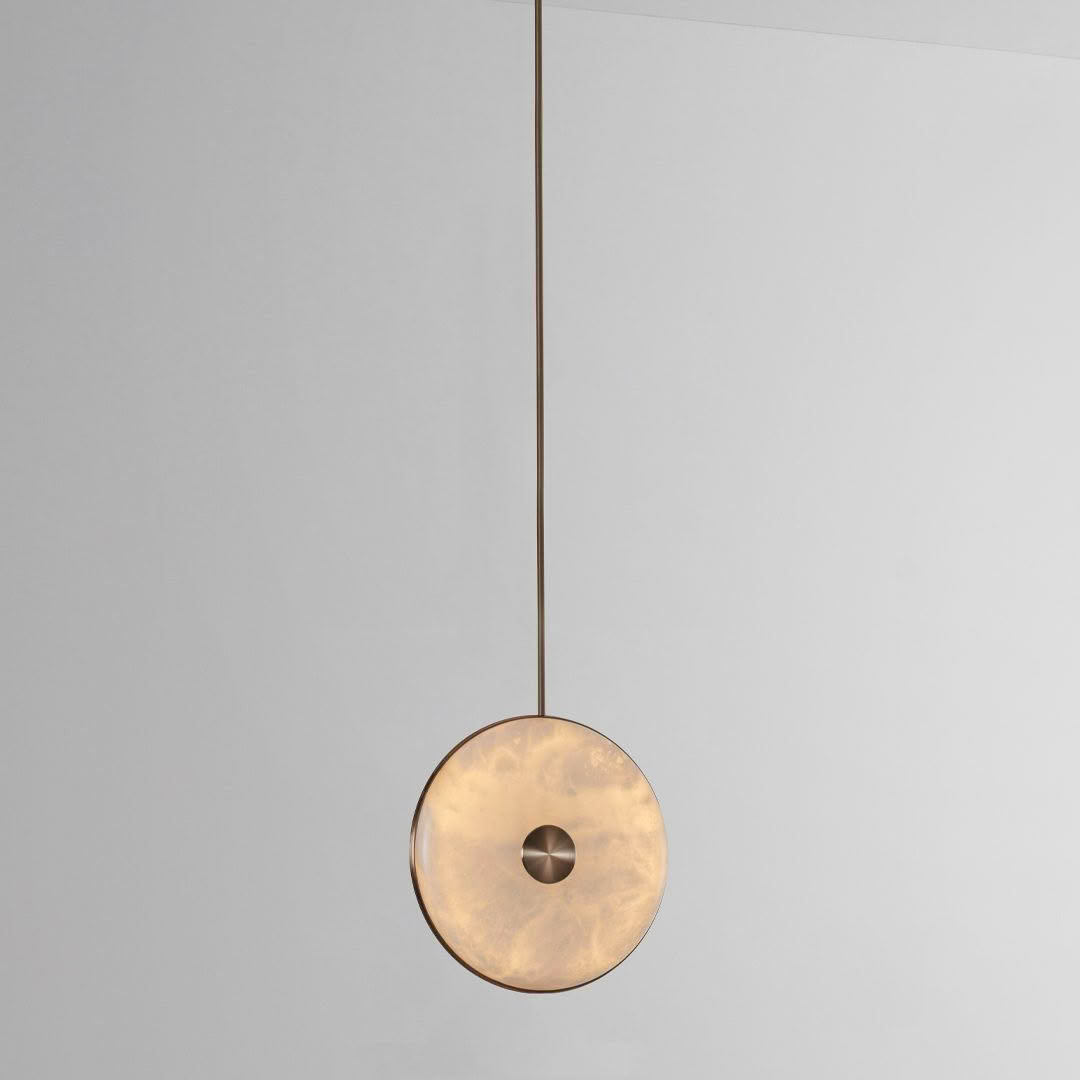 Modern circular pendant light with golden hue